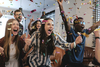 Zdjęcie przedstawiające grupę cieszących się młodych ludzi w chmurze confetti.